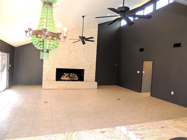 unfurnished living room with visible vents, high vaulted ceiling, a ceiling fan, a stone fireplace, and tile patterned flooring