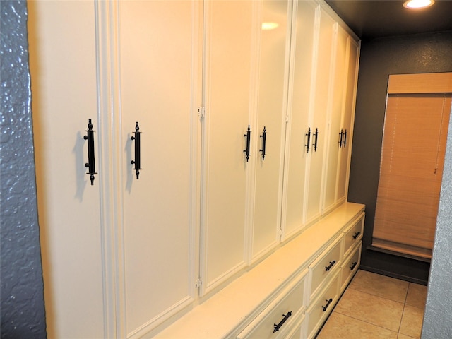 mudroom with light tile patterned floors and recessed lighting