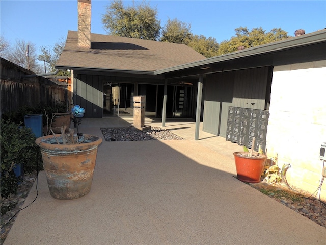 view of patio / terrace featuring mail area and fence