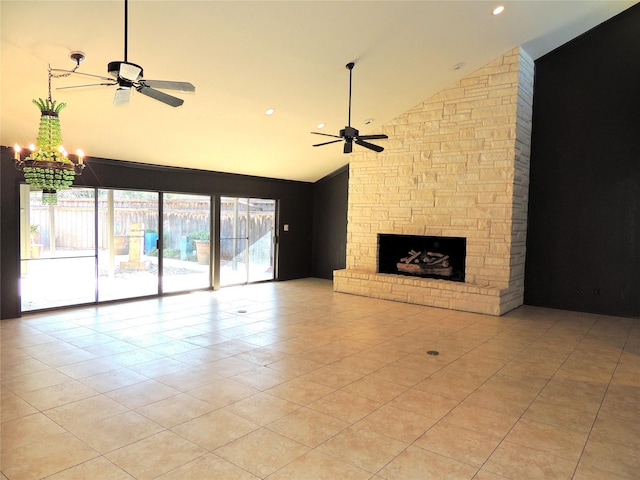 unfurnished living room with high vaulted ceiling, a stone fireplace, light tile patterned flooring, and ceiling fan with notable chandelier