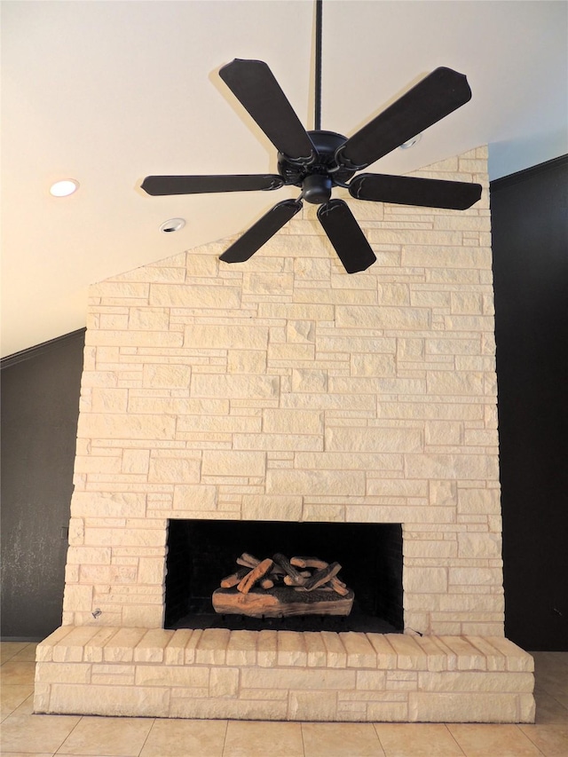 interior details featuring a stone fireplace and a ceiling fan