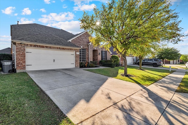 view of front of property featuring a front lawn, a garage, driveway, and a shingled roof