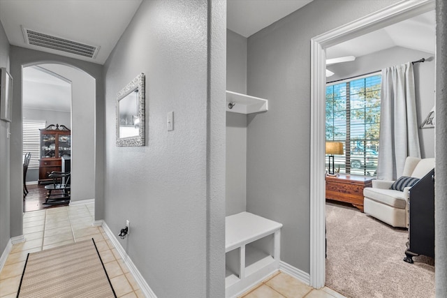 2604 Leisure Ln, Little Elm, TX 75068 - mudroom featuring arched walkways, light tile patterned flooring, a textured wall, and baseboards