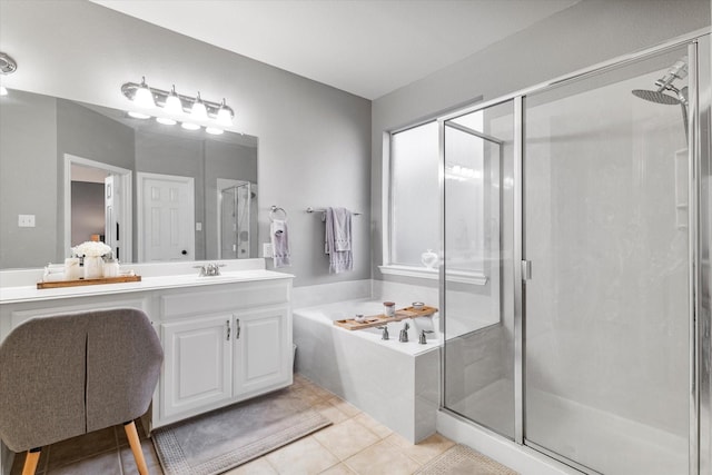 full bath with tile patterned flooring, a stall shower, vanity, and a garden tub