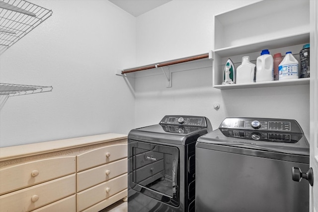 washroom featuring washer and clothes dryer and laundry area