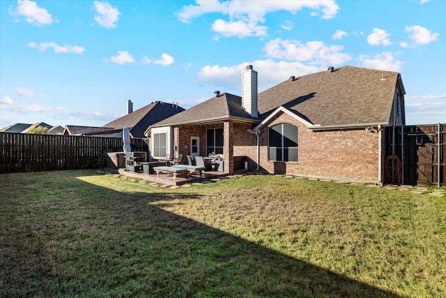 rear view of property featuring a lawn, a patio, a fenced backyard, roof with shingles, and brick siding