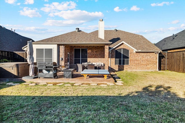 rear view of house with a yard, a fenced backyard, outdoor lounge area, and a hot tub