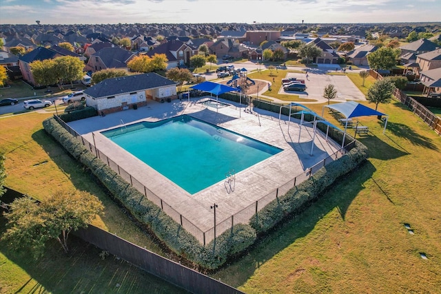 community pool featuring a residential view, a patio, and fence