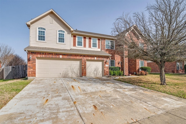 view of front of house featuring a front yard, fence, an attached garage, concrete driveway, and brick siding