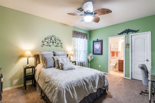 carpeted bedroom featuring visible vents, baseboards, a ceiling fan, and ensuite bathroom