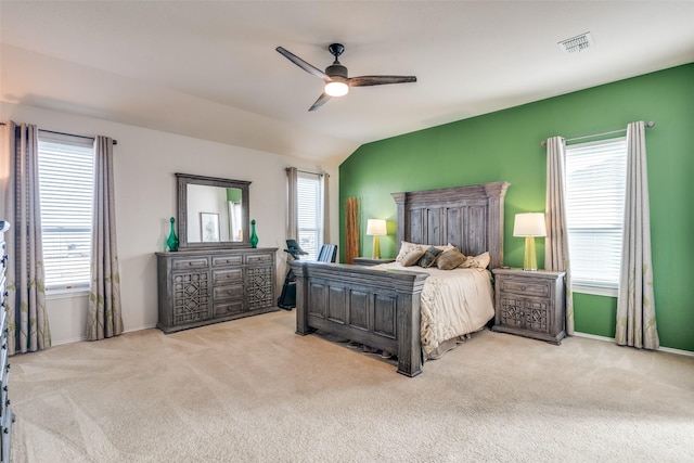 bedroom featuring visible vents, a ceiling fan, carpet floors, baseboards, and vaulted ceiling