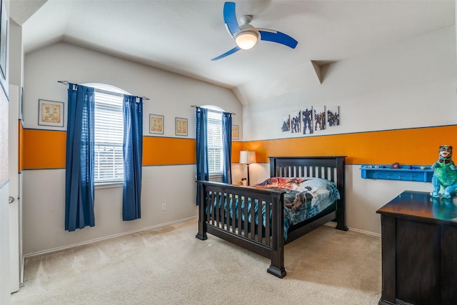 carpeted bedroom with baseboards, a ceiling fan, and vaulted ceiling