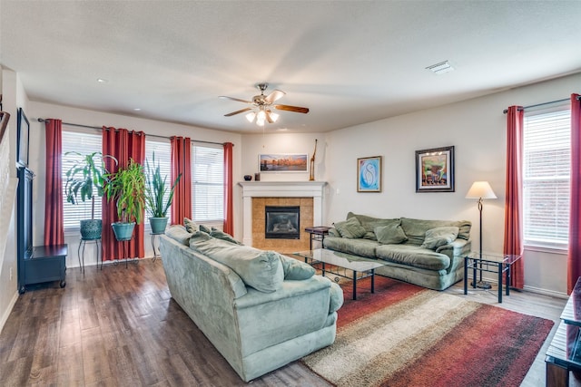 living room featuring visible vents, a healthy amount of sunlight, and wood finished floors