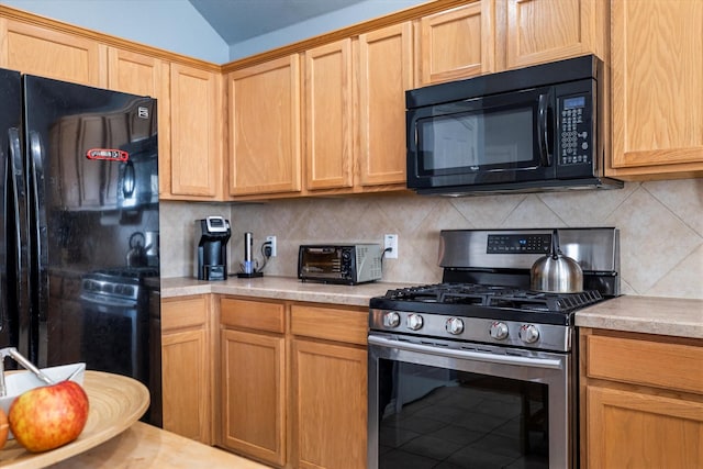 kitchen with black appliances, a toaster, decorative backsplash, light countertops, and vaulted ceiling