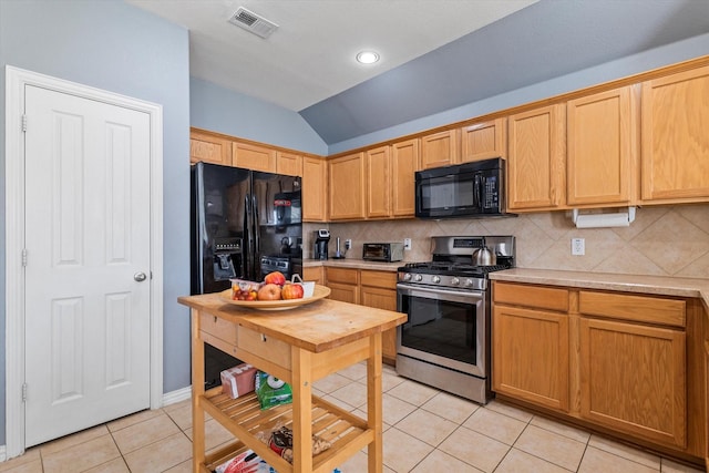 kitchen with light tile patterned flooring, visible vents, black appliances, and light countertops