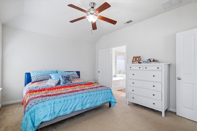 bedroom featuring ensuite bath, vaulted ceiling, visible vents, and light carpet