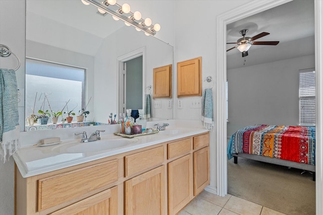 bathroom featuring ceiling fan, double vanity, tile patterned floors, ensuite bath, and a sink