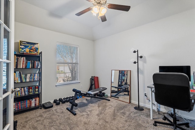 carpeted office space featuring baseboards, a ceiling fan, and vaulted ceiling