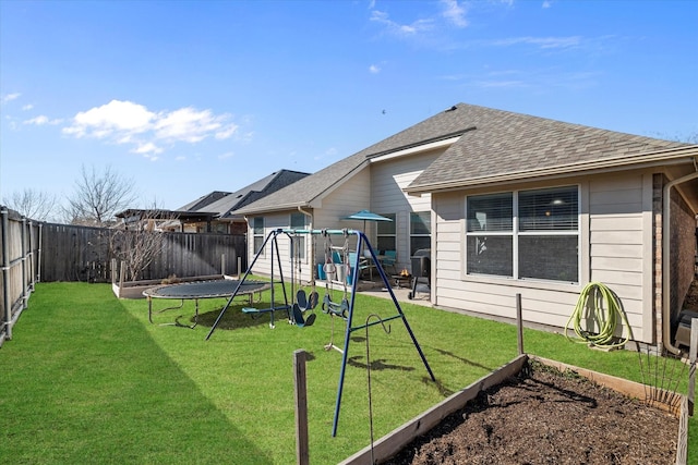 exterior space featuring a playground, a trampoline, and a fenced backyard