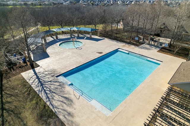 pool featuring a patio area, a hot tub, and fence