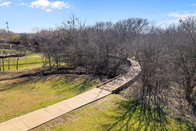 view of yard featuring a view of trees and fence