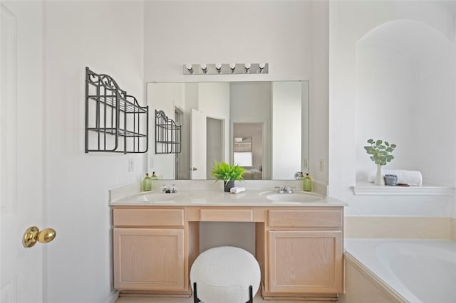 full bath with double vanity, a garden tub, and a sink