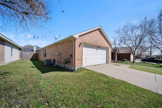 view of property exterior with a lawn, driveway, fence, brick siding, and central AC unit