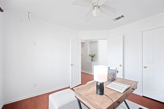 office with visible vents, baseboards, a ceiling fan, and wood finished floors