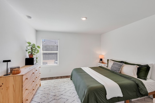 bedroom featuring light wood-style flooring and baseboards