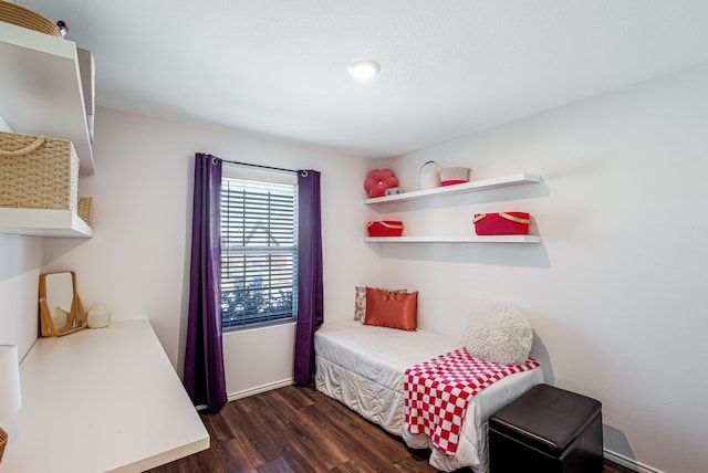 bedroom with dark wood finished floors