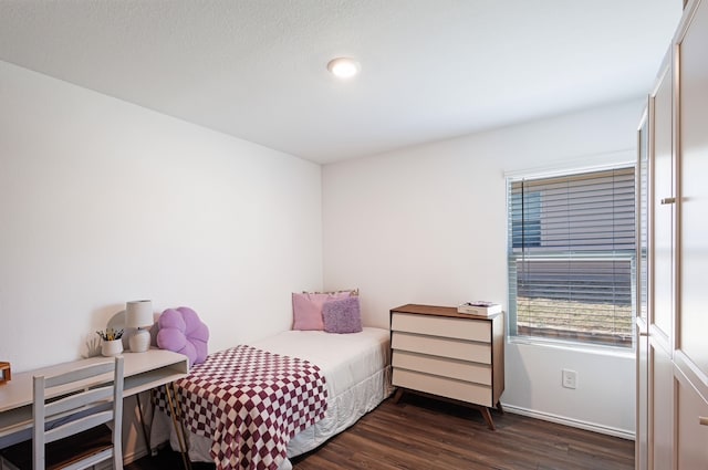 bedroom with dark wood finished floors