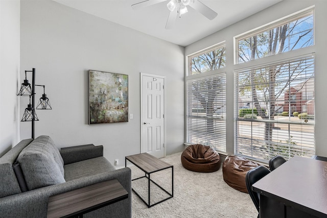 carpeted living room featuring a ceiling fan