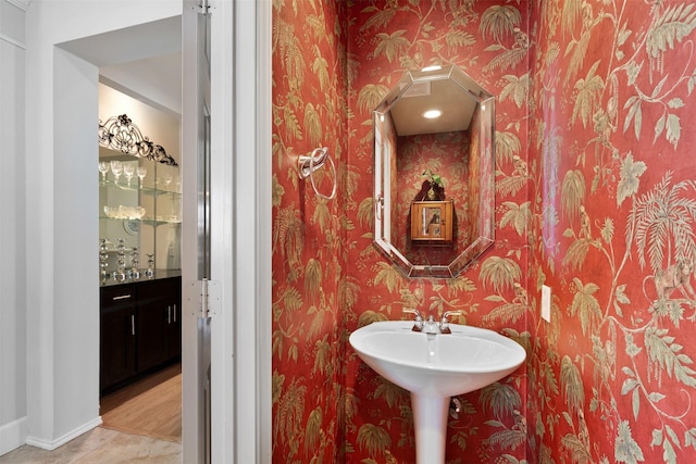 bathroom with wallpapered walls