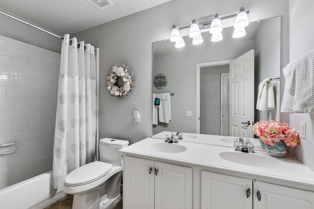 full bathroom with double vanity, toilet, shower / bath combo, and a sink