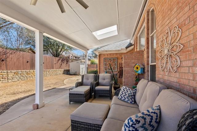 view of patio with outdoor lounge area, an outbuilding, a storage unit, and a fenced backyard