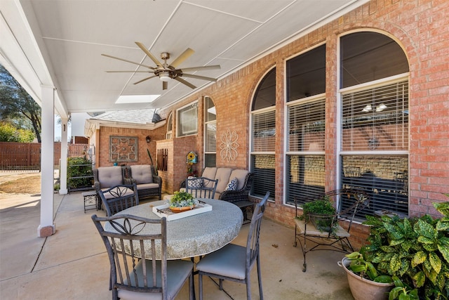 view of patio featuring outdoor lounge area, a ceiling fan, and fence