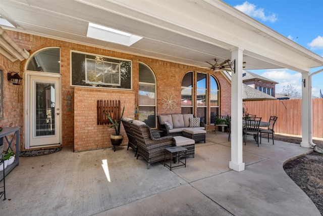 view of patio / terrace with an outdoor hangout area, a ceiling fan, and fence