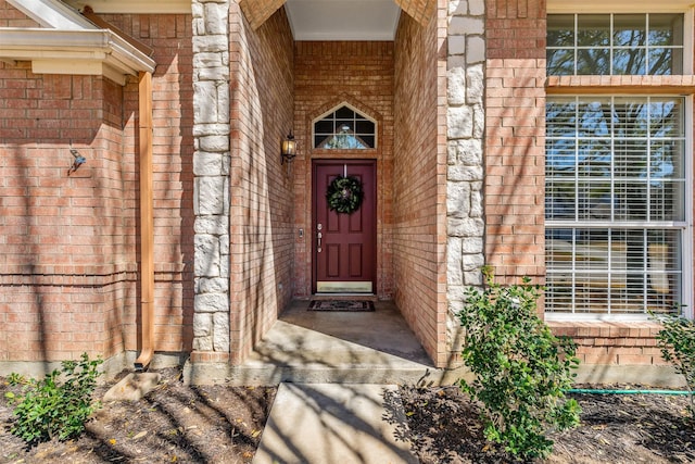 doorway to property featuring brick siding