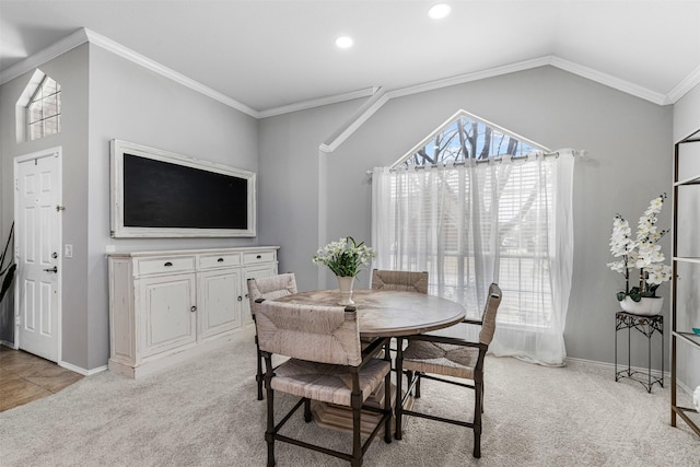 dining room with baseboards, lofted ceiling, recessed lighting, ornamental molding, and light carpet