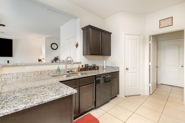 kitchen featuring light stone counters, light tile patterned floors, a sink, dark brown cabinetry, and black dishwasher