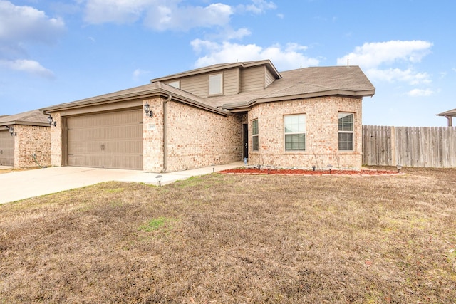 view of front of home featuring brick siding, driveway, an attached garage, and fence