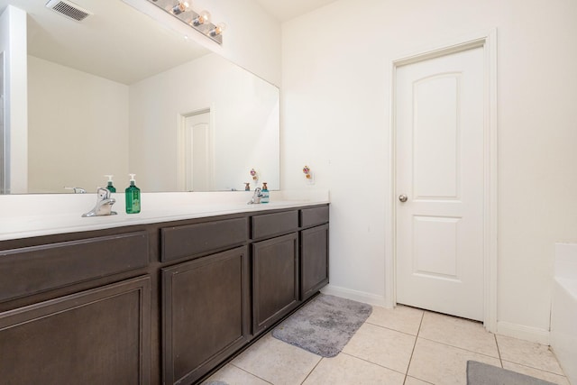 full bathroom featuring visible vents, double vanity, a sink, tile patterned floors, and a washtub