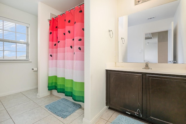 bathroom featuring tile patterned floors, visible vents, baseboards, and vanity