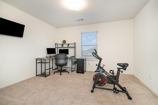 carpeted office space with visible vents and baseboards