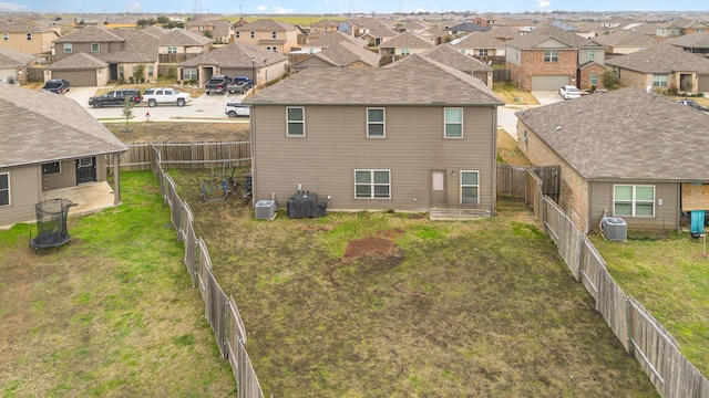 back of house with a residential view, central AC unit, and a fenced backyard