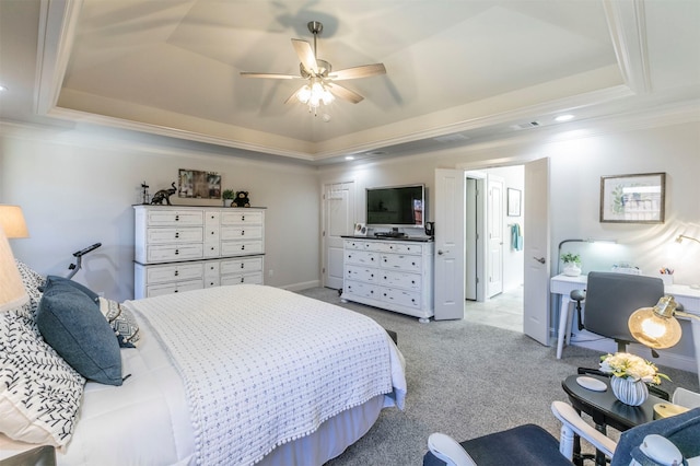 bedroom with visible vents, light colored carpet, a tray ceiling, ornamental molding, and a ceiling fan