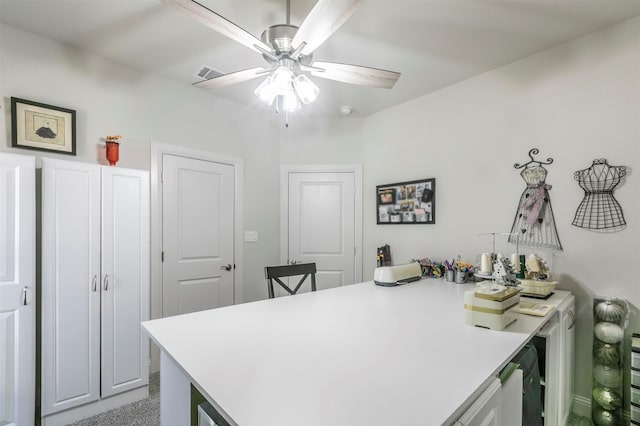 home office with visible vents, light colored carpet, and ceiling fan