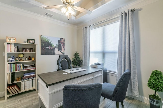 office area featuring baseboards, visible vents, ceiling fan, ornamental molding, and light wood-type flooring