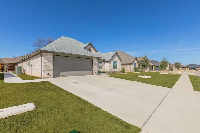 french provincial home with fence, roof with shingles, concrete driveway, a front yard, and a garage