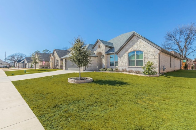 french provincial home featuring stone siding, driveway, a front lawn, and a garage